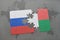 puzzle with the national flag of russia and madagascar on a world map background.