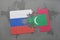 puzzle with the national flag of russia and maldives on a world map background.