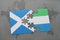 puzzle with the national flag of scotland and sierra leone on a world map