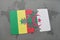 puzzle with the national flag of senegal and algeria on a world map