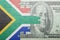 Puzzle with the national flag of south africa and dollar banknote