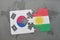 puzzle with the national flag of south korea and kurdistan on a world map background.