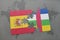 puzzle with the national flag of spain and central african republic on a world map background.