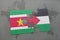 puzzle with the national flag of suriname and palestine on a world map