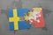 puzzle with the national flag of sweden and bhutan on a world map background.