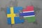 puzzle with the national flag of sweden and gambia on a world map background.