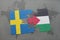 puzzle with the national flag of sweden and palestine on a world map background.