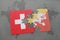 puzzle with the national flag of switzerland and bhutan on a world map background.