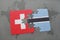 Puzzle with the national flag of switzerland and botswana on a world map background. 3D illustration