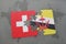 puzzle with the national flag of switzerland and brunei on a world map background.