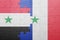 Puzzle with the national flag of syria and france