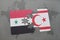 puzzle with the national flag of syria and northern cyprus on a world map background.