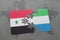 puzzle with the national flag of syria and sierra leone on a world map