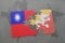 puzzle with the national flag of taiwan and bhutan on a world map background.