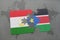 puzzle with the national flag of tajikistan and south sudan on a world map