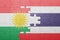 Puzzle with the national flag of thailand and kurdistan