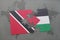 puzzle with the national flag of trinidad and tobago and palestine on a world map