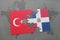 puzzle with the national flag of turkey and dominican republic on a world map