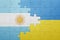 puzzle with the national flag of ukraine and argentina