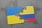 puzzle with the national flag of ukraine and colombia on a world map