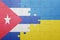 puzzle with the national flag of ukraine and cuba