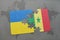 puzzle with the national flag of ukraine and senegal on a world map