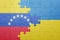 puzzle with the national flag of ukraine and venezuela