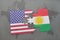 puzzle with the national flag of united states of america and kurdistan on a world map background