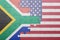 Puzzle with the national flag of united states of america and south africa