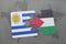 puzzle with the national flag of uruguay and palestine on a world map