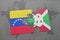 puzzle with the national flag of venezuela and burundi on a world map
