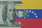 puzzle with the national flag of venezuela and dollar money banknote. macro.concept