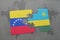 puzzle with the national flag of venezuela and rwanda on a world map