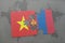 puzzle with the national flag of vietnam and mongolia on a world map background.