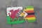 puzzle with the national flag of wales and zimbabwe on a world map