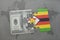 puzzle with the national flag of zimbabwe and dollar banknote on a world map background.