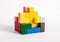 Puzzle toy with geometric blocks of bright colors. Logical thinking, hand-eye coordination development, concentration