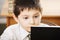 Puzzled caucasian boy reading book closeup