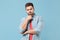 Puzzled pensive young bearded guy 20s in casual shirt posing isolated on pastel blue wall background studio portrait