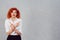 Puzzled. Portrait of baffled redhead curly woman pointing in opposite directions not sure where to go, what to do next in life,