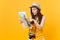 Puzzled traveler tourist woman in summer casual clothes, hat looking on city map isolated on yellow orange background