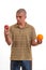 Puzzled young man confused, choice between an apple an an orange