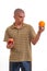 Puzzled young man confused, what to choice between an apple an an orange