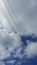 Pylon cables against a blue sky and cloud