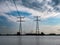 Pylons and power lines over Ramsdiep canal of Zwarte Meer lake, Netherlands