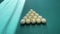 Pyramid of balls on the green field of Russian billiards, ivory balls, break the pyramid of balls. Long shadows on the