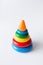 Pyramid build from colored rings with a clown head on top. Toy for babies and toddlers to joyfully learn mechanical skills and