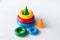 Pyramid build from colored rings with a clown head on top. Toy for babies and toddlers to joyfully learn mechanical skills