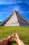 Pyramid Castillo in Chichen itza and relaxing legs on grass