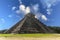The pyramid of Chichen Itza in honor of the God Kukulkan the feathered serpent under a beautiful tropical blue sky